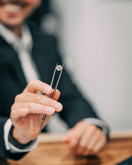 Man Looking at Loose Diamond