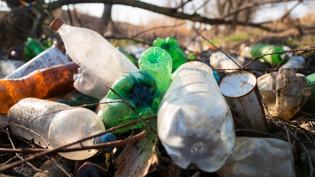 A pile of plastic bottles on the ground.