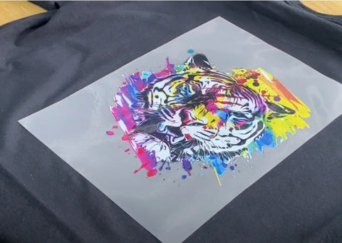 DTF image of a colourful tiger on a DTF sheet acetate ready to press