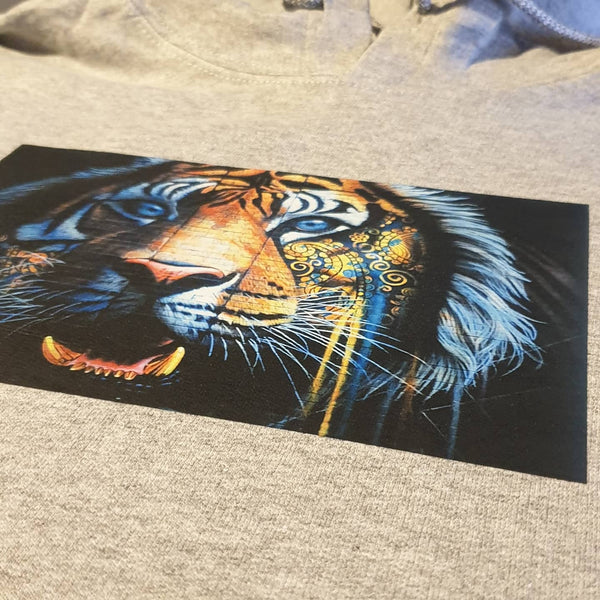 A DTG print grey hoodie with a colourful image of a tiger.  The image is a graffiti style with dripping paint.