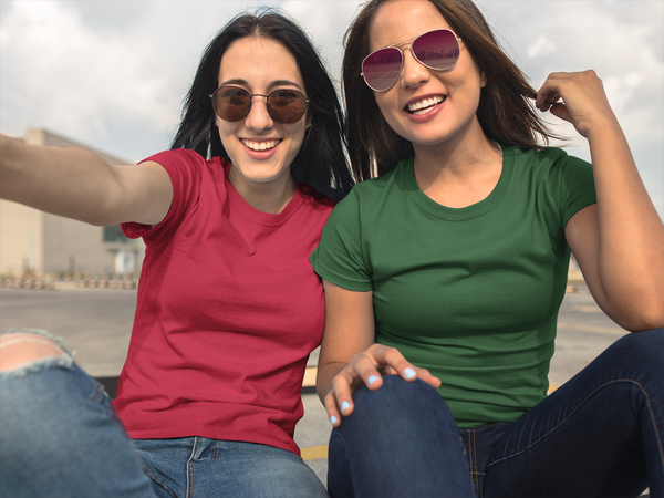 Two happy, smiling, young attractive women wearing T-shirts