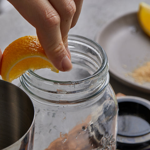 Moisten the rim of a glass with lemon 