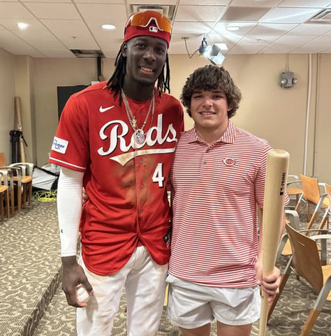 A photo of Elly De La Cruz posing with the fan that caught his first homerun ball