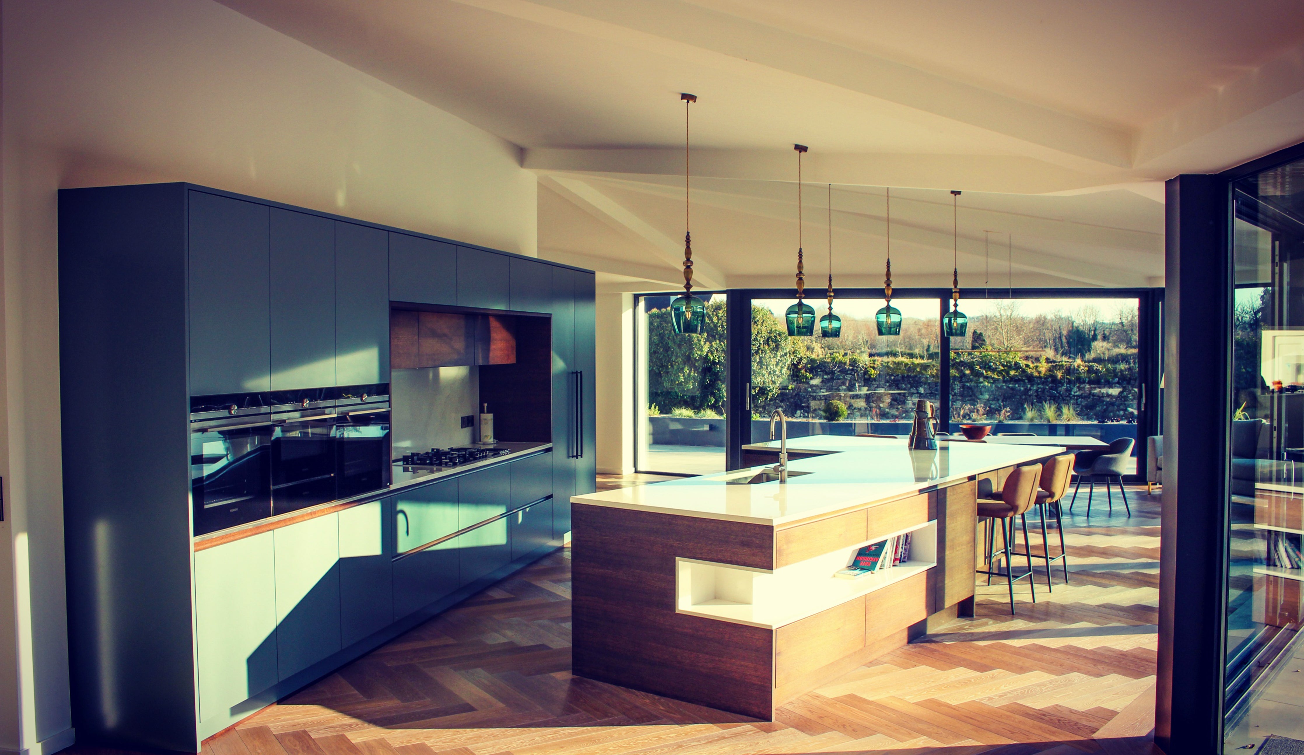 Standing Pendants by Rothschild &amp; Bickers hanging over kitchen island by Kestrel Interiors