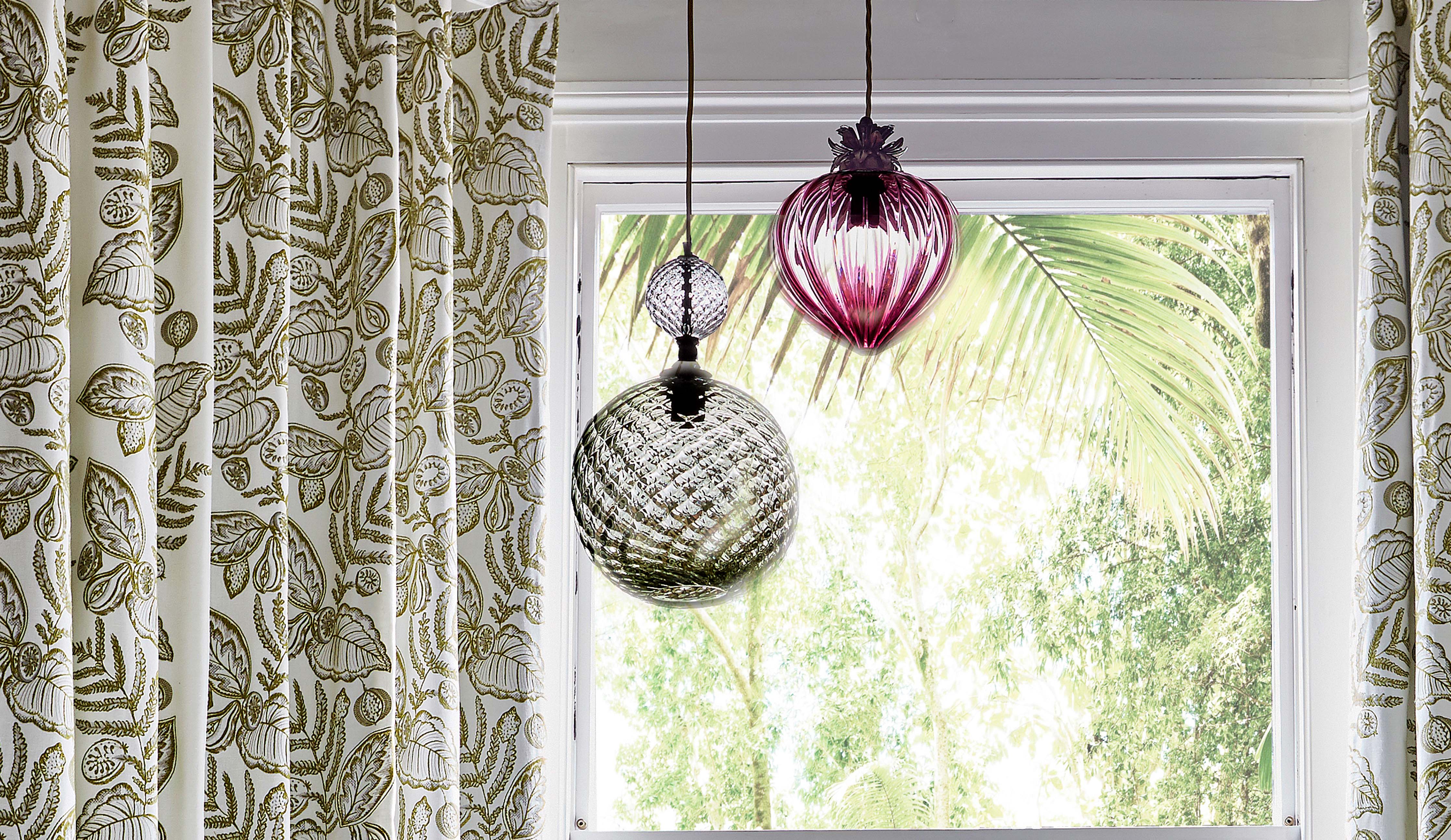 Coloured glass pendant lighting lamps by Rothschild &amp; Bickers  hanging with floral fabric by Prestigious Textiles