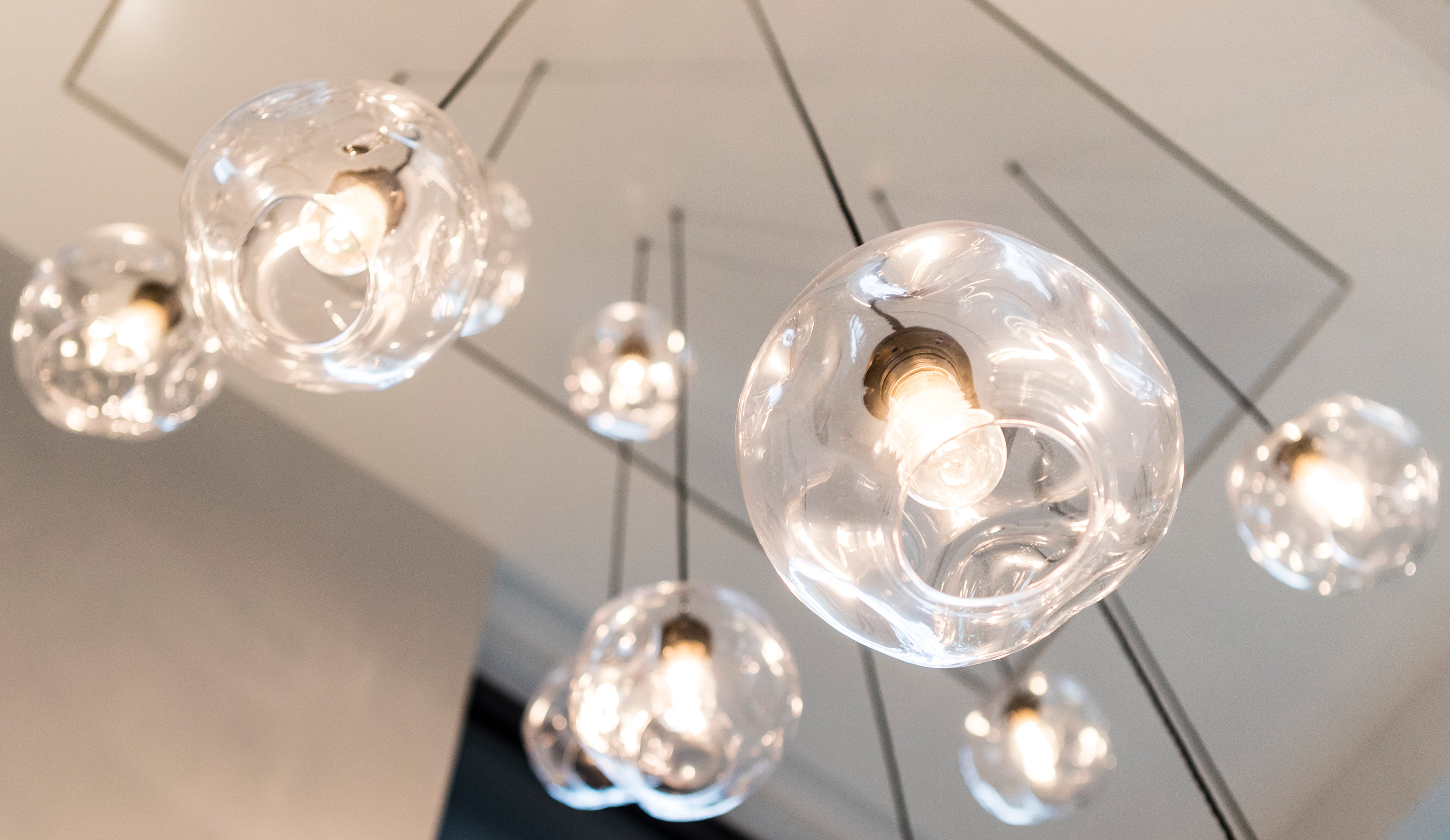 Clear Liquid Lights by Rothschild &amp; Bickers hanging on ceiling plate in stairwell atrium