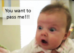 Snugglebundl - Importance of Supporting a Baby’s Head Blog - Image of a baby looking shocked with caption 'You want to pass me!!!'