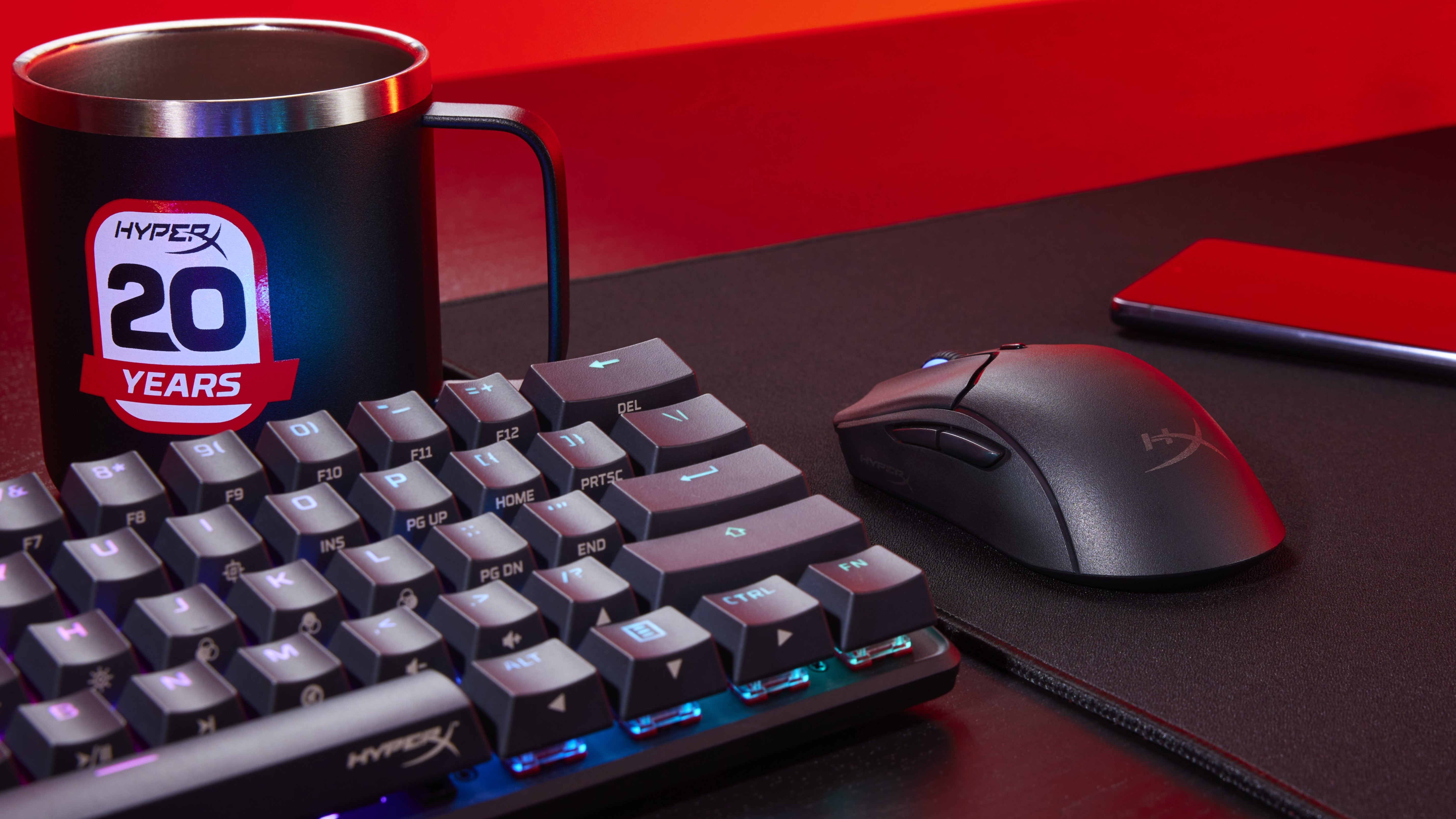 Pulsefire Haste 2 mini wireless on desk with coffee cup and gaming keyboard