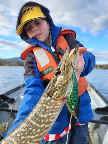 Child Angler with Pike with Forge of Lures Jerkbait in mouth