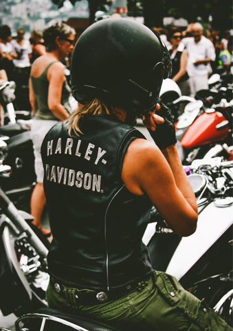 girl with Harley Davidson vest on motorcycle