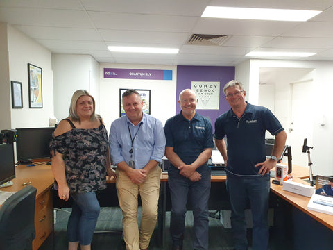 Leanne Lansdown, Michael Palmer, Nick Powell and Peter Cracknell leaning against a desk in the Queensland office