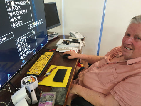 Bill sitting at his desk with bridge on hos computer screen 