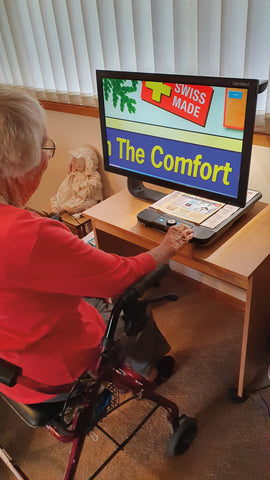 Shirley using her ClearView to read a magazine