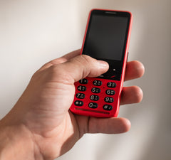 Hand holding red mobile phone