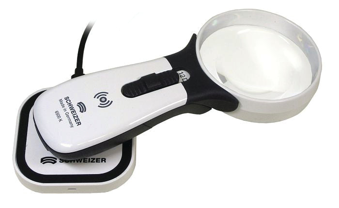 Hand held magnifier on charging pad