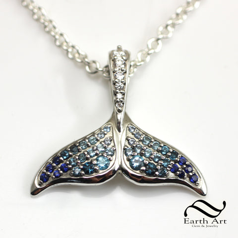 Faded blue gemstones in a whale tail pendant