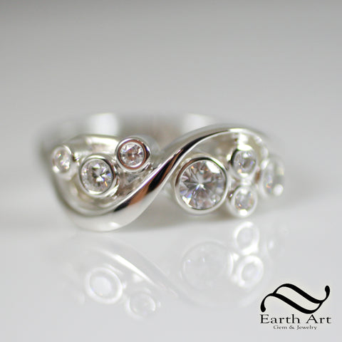 Swirls of silver around moissanite gemstones in this wavy conceptual ring.