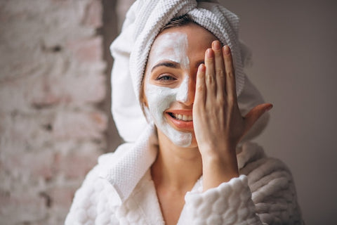 women applying face cream on face