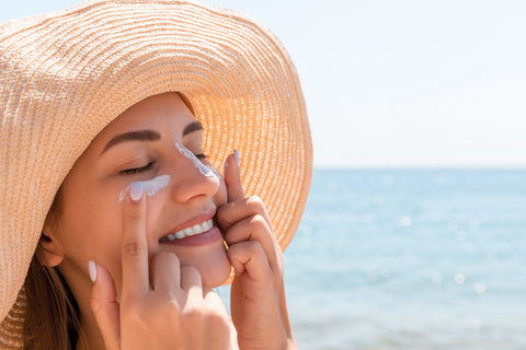 woman is applying sunscreen.