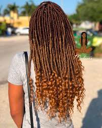 A back woman using crochet locs as a gentle protective style.