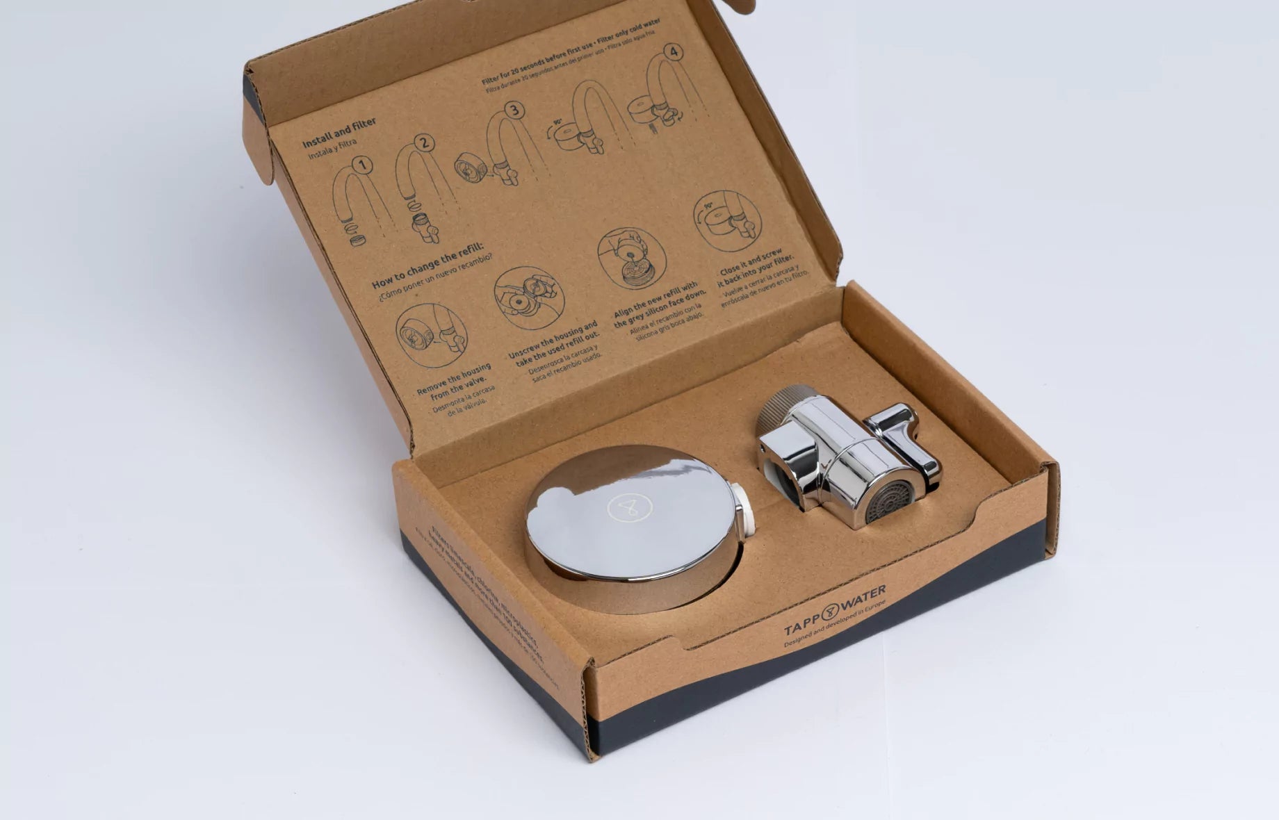 An open box with a water filter and installation instructions printed inside the lid.