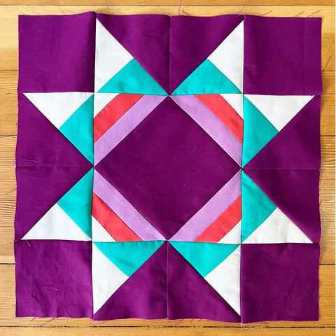 The Dark Sky block, with a purple background and light purple, teal, white, and coral shapes