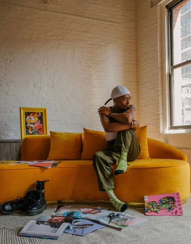 Kendrick Daye on Infinity sofa in Marigold velvet