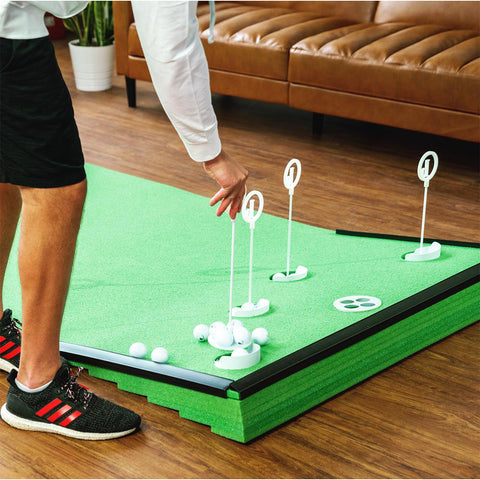 man playing with the elevated putting green mat
