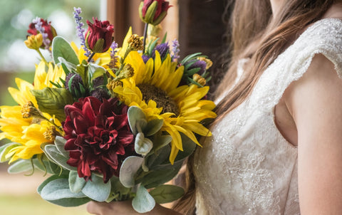 bride holding a beautiful bouquet of sunflowers