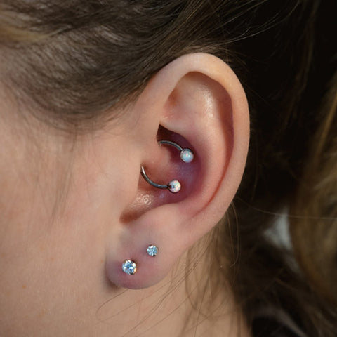 Helix piercing: pain, healing, jewelry - obsidian piercing