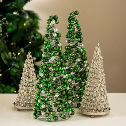 Four Christmas tree cones adorned with baubles and crystals. The middle two are green and white and the outer two are all clear crystals.