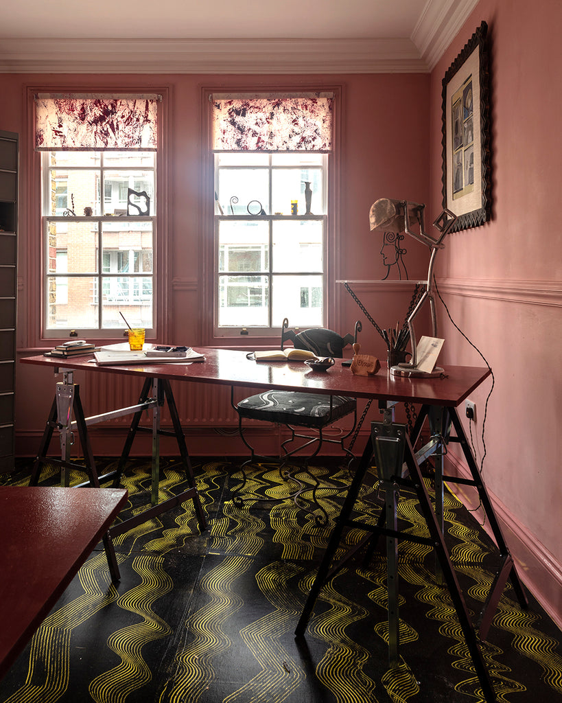 Trestle table desk set at angle in a pink painted room