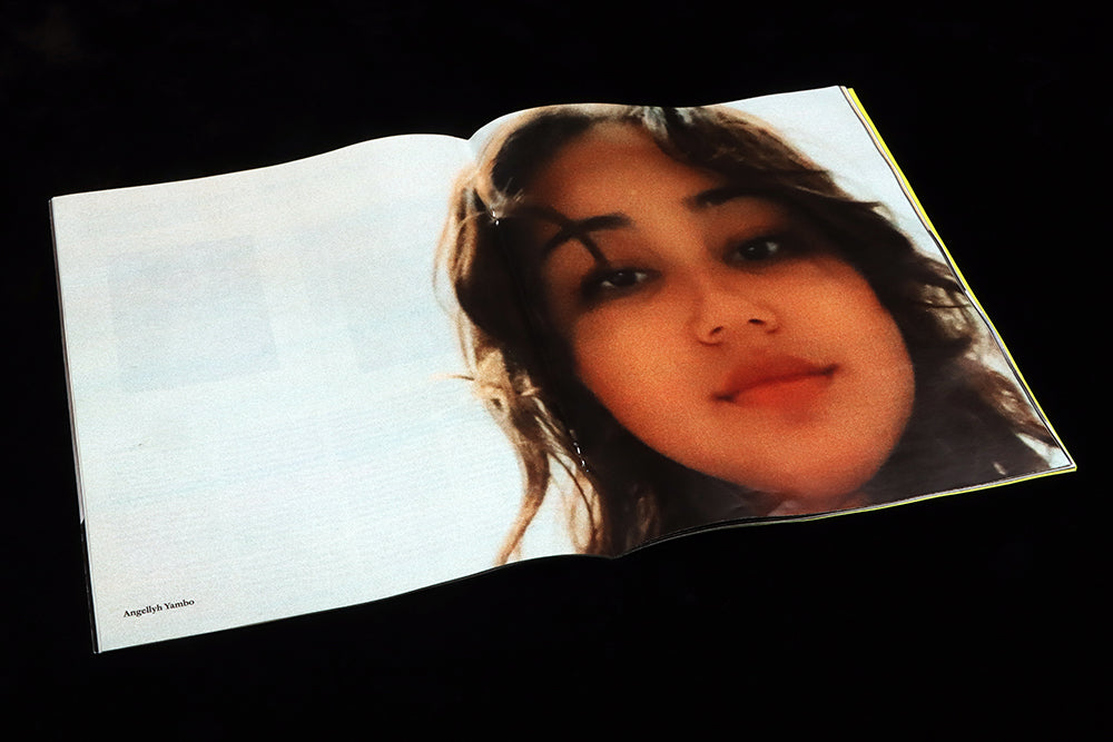 Double page image of a young woman, slightly blurred, blown up from a phone image.