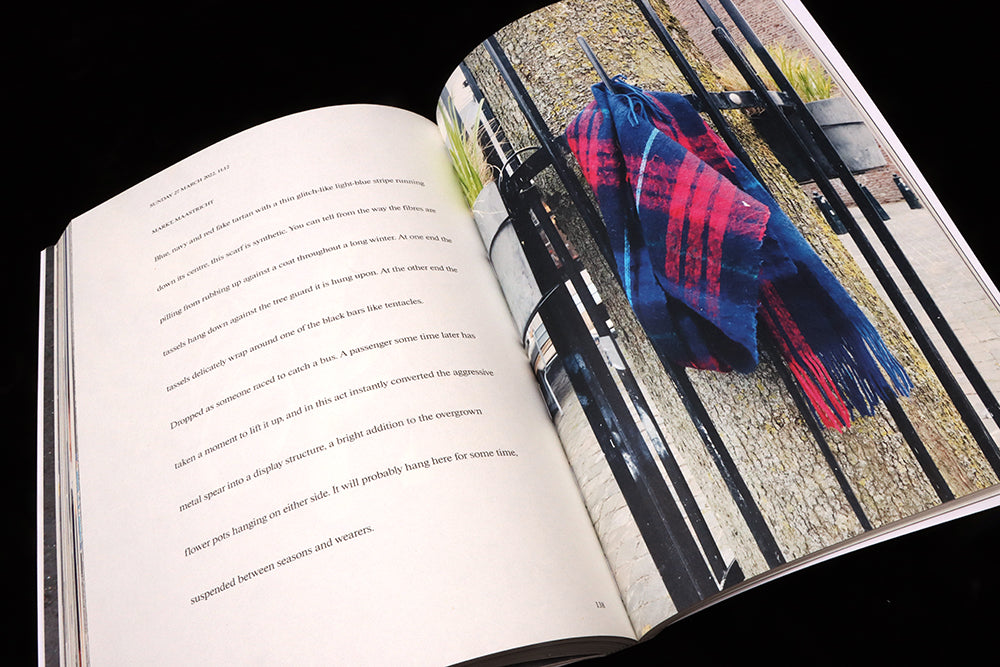 A spread from Vestoj 11: on left, text, on the right, a dirty woollen scarf hangs from a tree guard.