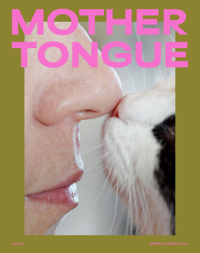 The front cover of Mother Tongue issue four, a woman and cat touch noses.