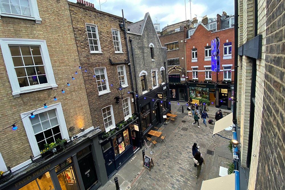 Shot from window showing buildings and cobbled street