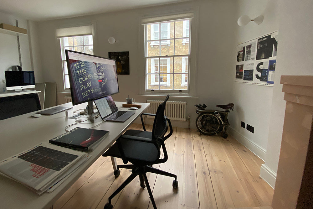 Office interior, wooden floor and desk with monitor.