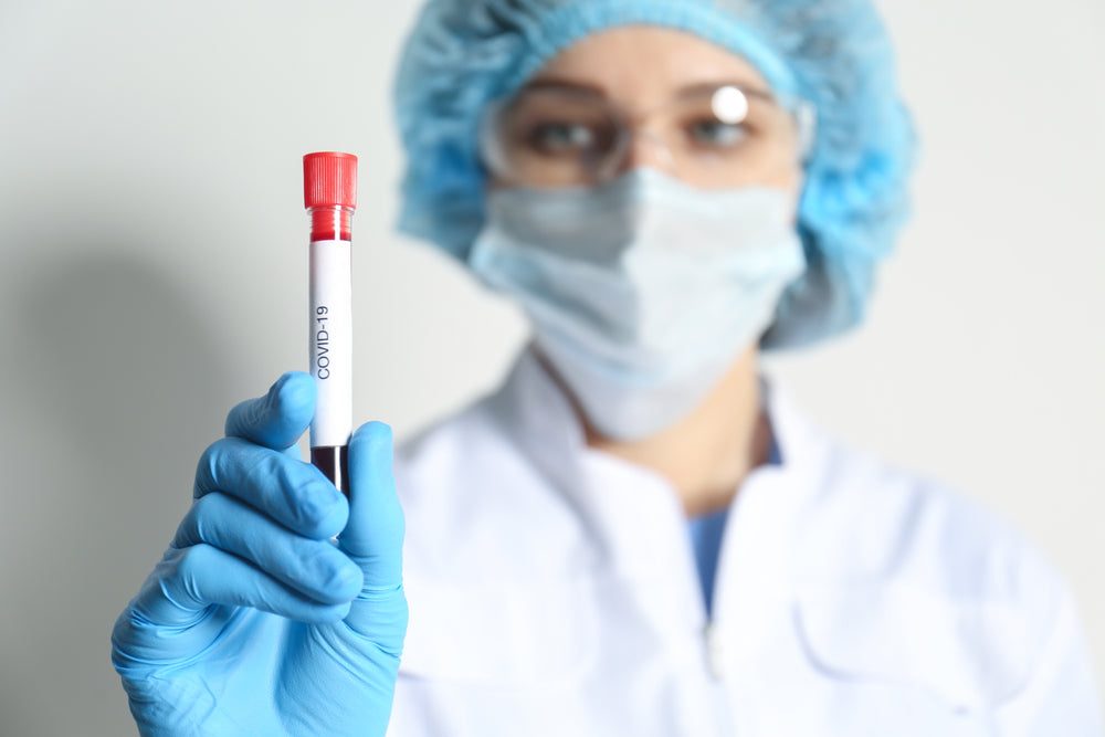 Scientist holding Covid Test