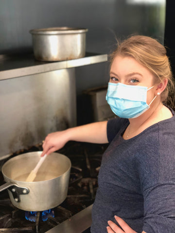 Photo of Haley Loyet creating a champagne reduction for the strawberries and champagne bar