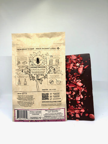 Photo of the packaging for the strawberries and champagne bar along with the bar itself with dried strawberries on the back of the bar