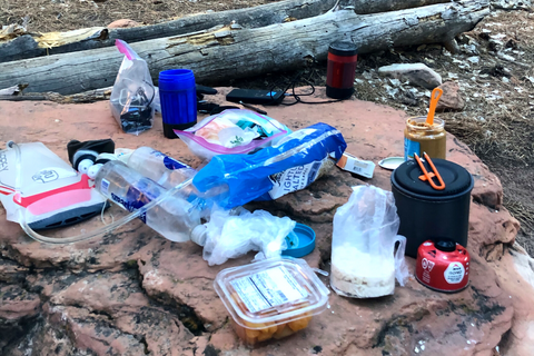 Camping food set out on a rock at a campsite