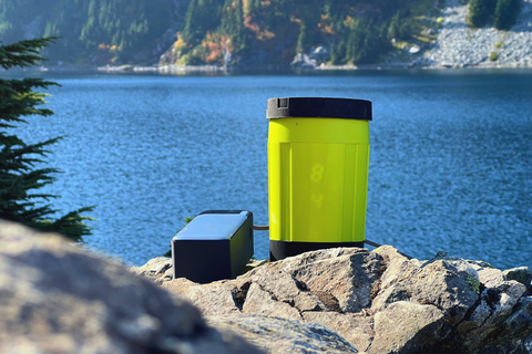 EcoSimmer Electric Backpacking Stove and Battery by an alpine lake