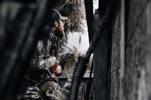 2 men sitting in deer stand hunting