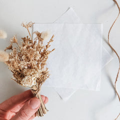 Wrapping a dried flower posy.