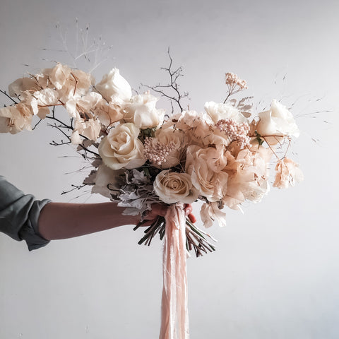 Bridal bouquet featuring fresh and dried flowers.