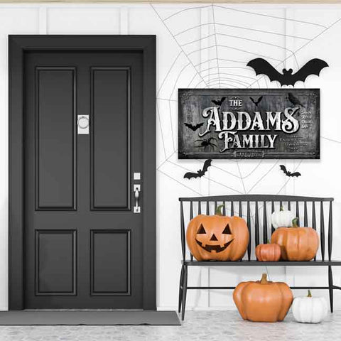 Personalized family name Halloween sign. Black and gray canvas with black bats and spiders. Has family member's names and "enter at your own risk". 