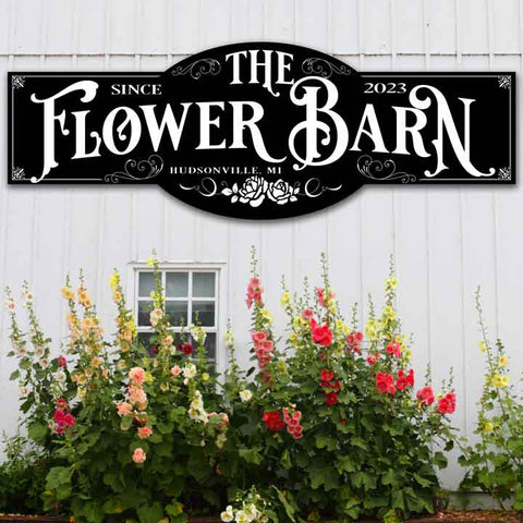 Ornate Outdoor Metal Barn Sign. Black Metal With Ornate White Font that Reads "The Flower Barn"