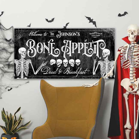 Halloween Wall Art with Skeletons Reads "Bone Appetit, Dead & Breakfast"