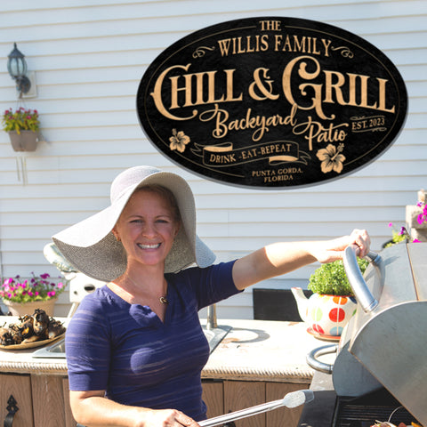 bar and grill sign chill and grill on black textured oval sign with woman in front grilling