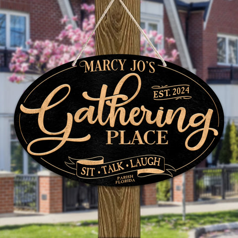 Patio Decor Sign of an oval metal sign hanging on a pole with the words Marcy Jo's Gathering Place